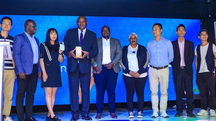 Minister of ICT and National Guidance; Hon. Dr. Chris Baryomunsi (4th from left) pose for a group photo with officials from Tecno Mobile Uganda and Airtel Uganda after the launch Tecno Spark 20 Pro+.