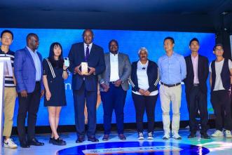 Minister of ICT and National Guidance; Hon. Dr. Chris Baryomunsi (4th from left) pose for a group photo with officials from Tecno Mobile Uganda and Airtel Uganda after the launch Tecno Spark 20 Pro+.