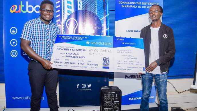 Ogwal Joseph; Founder and Chief Executive (Left), and Watson Atwine (Right); IT Specialist who represented the team, recivce their victory dummy air ticket at the Seedstar Kampala competition at Outbox Hub on Friday 24th, August 2018. This is Seedstars Kampala competition winners.