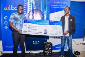 Ogwal Joseph; Founder and Chief Executive (Left), and Watson Atwine (Right); IT Specialist who represented the team, recivce their victory dummy air ticket at the Seedstar Kampala competition at Outbox Hub on Friday 24th, August 2018. This is Seedstars Kampala competition winners.