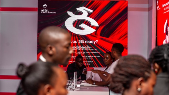 Guests at the unveiling of the Airtel Uganda's 5G network at Serena Hotel pass by an Airtel 5G display board in the background. PHOTO: PC Tech Magazine