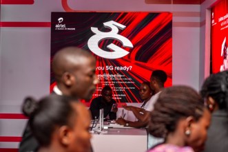 Guests at the unveiling of the Airtel Uganda's 5G network at Serena Hotel pass by an Airtel 5G display board in the background. PHOTO: PC Tech Magazine