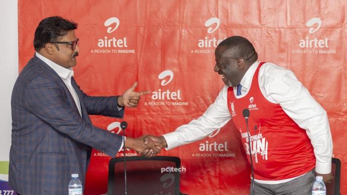 Manoj Murali (left), Managing Director of Airtel Uganda and Hon. Nyombi Thembo (right), UCC Executive Director shake hands after the handover of a cheque of UGX34.8bn to UCC from Airtel Uganda to support Uganda's development of rural communications infrastructure. PHOTO: PC Tech Magazine