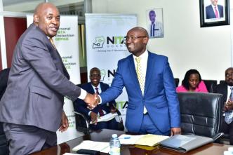 Minister of ICT and National Gudiance, Hon. Chris Baryomunsi (left) congratulating Alexander Kibandama on his appointment as the new Chairperson Board of Directors, NITA-U.