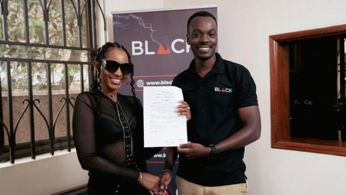 Namukwaya Hajara Diana, also known as Spice Diana (left) shakes hands with Mourice Aliganyira, Head of Marketing at BLACK after announcing their partnership.