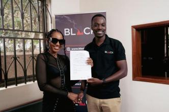 Namukwaya Hajara Diana, also known as Spice Diana (left) shakes hands with Mourice Aliganyira, Head of Marketing at BLACK after announcing their partnership.