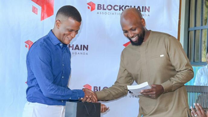 Reginald Tumusiime (left); Chairman of Blockchain Association of Uganda with the former Chairman; Kwame Rugunda. Courtesy Photo/FILE PHOTO