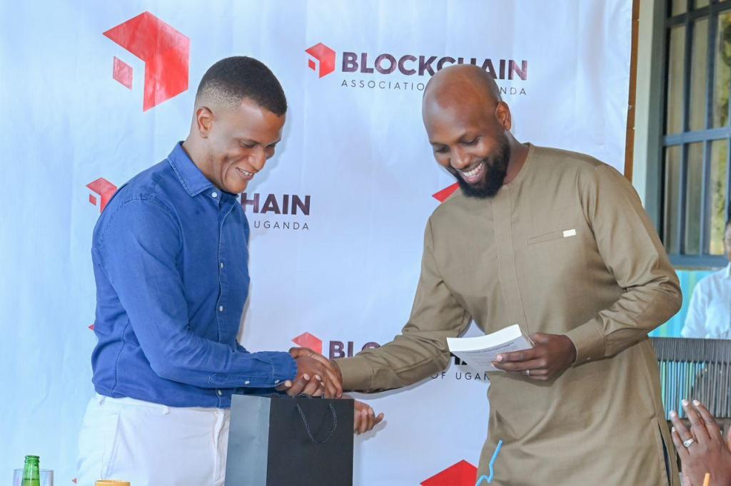 Reginald Tumusiime (left); Chairman of Blockchain Association of Uganda with the former Chairman; Kwame Rugunda. Courtesy Photo/FILE PHOTO