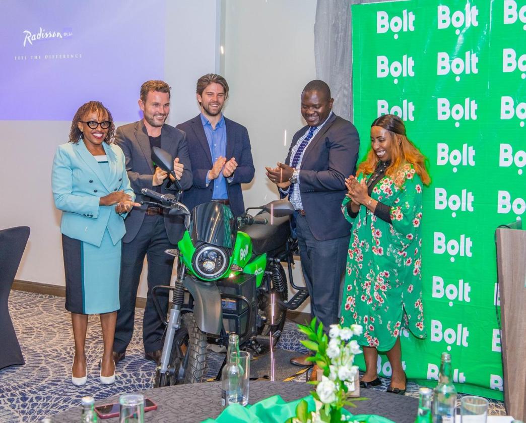 In Pictorial (R-L): Caroline Wanjihia; Bolt Regional Director in Africa, David Damberger; Managing Director of M-KOPA Mobility, Mikael Gånge; CCO of ROAM, Ken Onyango; Chair of the Nairobi Transport Committee and Evaline Wawuda; Sales Coordinator of ROAM pose for a group photo with an electric motorcycle after announcing Bolt and M-KOPA partnership. COURESTY PHOTO