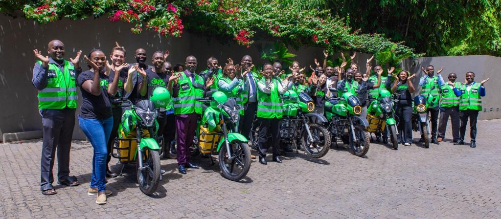 Representatives from Bolt, MKOPA, ROAM and Ampersand with a group of riders pose for a group photo after the announcement of Bolt and M-KOPA launched electric motorcycles in Kenya to improve driver earnings and combat climate change. COURESTY PHOTO