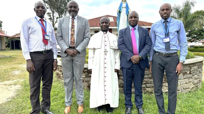 Cente-Tech’s CTO, Peter Kahiigi (2nd from right) and other Cente-Tech officials pose for a group with Bishop Robert Muhiirwa, Fort Portal Catholic Diocese. COURTESY PHOTO