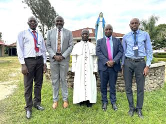 Cente-Tech’s CTO, Peter Kahiigi (2nd from right) and other Cente-Tech officials pose for a group with Bishop Robert Muhiirwa, Fort Portal Catholic Diocese. COURTESY PHOTO