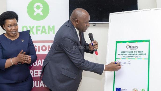 Dr. Chris Baryomunsi, Minister of ICT and National Guidance signs pluck card as a sign for the launch of the ReCIPE Project, an initiative of Oxfam and the Center for Constitutional Governance at Fairway Boutique Hotel in Kampala. PHOTO: PC Tech Magazine