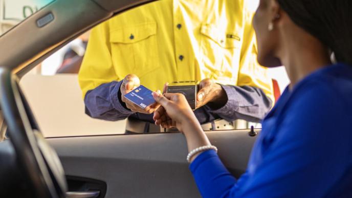 A customer pictured paying using a visa card. COURTESY PHOTO