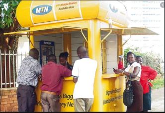 Customers pictured at an MTN MoMo kiosk. (FILE PHOTO)