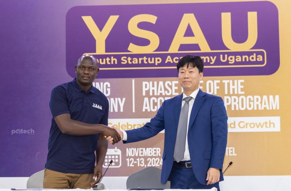 Mr. Isaac Kiwanda (left) and Mr. Park (right) shake hands after signing the Memorandum of Understanding (MoU) for direct investment. PHOTO: PC Tech Magazine