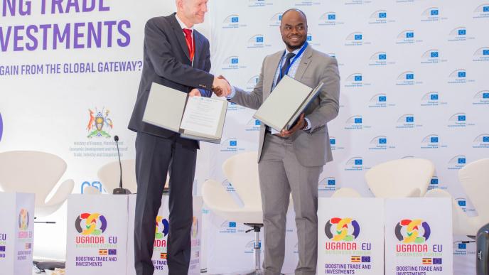 Edward Claessen (left); EIB Head of the Regional Hub for East Africa and Geoffrey Donnels Oketayot (right); CEO of TowerCo of Africa Uganda shake hands on the sidelines of the Uganda-EU Business Forum. COURTESY PHOTO