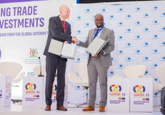 Edward Claessen (left); EIB Head of the Regional Hub for East Africa and Geoffrey Donnels Oketayot (right); CEO of TowerCo of Africa Uganda shake hands on the sidelines of the Uganda-EU Business Forum. COURTESY PHOTO