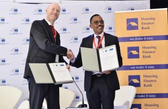 Edward Claessen (left); EIB Head of the Regional Hub for East Africa and Michael Mugabi (right); CEO of Housing Finance Bank shake hands after unveiling a €50 million (UGX212.8 billion) investment partnership. COURTESY PHOTO