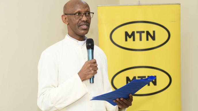 Fr. Eugene Safari, the Rector of St. Joseph’s Seminary Nyenga speaking at the handover ceremony of a newly built computer lab by MTN Foundation to the school. Courtesy Photo