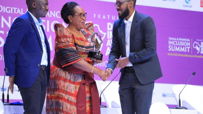 FutureLink Technologies representative (right) collects HiPipo Digital Impact Award from the State Minister of ICT, Hon. Joyce Ssebugwawo. COURTESY PHOTO