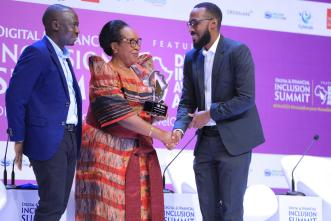 FutureLink Technologies representative (right) collects HiPipo Digital Impact Award from the State Minister of ICT, Hon. Joyce Ssebugwawo. COURTESY PHOTO