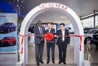 (left to right) Eng. Dr. Timothy Tibesigwa, Double Q Managing Director; Bruce Lin, and a global representative from GWM unveiling cutting the ribbon to officially unveil the GWM showroom in Uganda while looks on. PHOTO: PC Tech Magazine