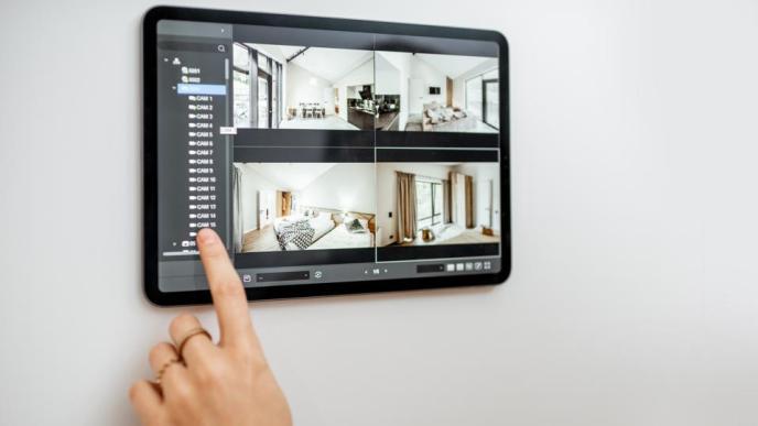 A person pictured looking on camera system installed at their home. (COURTESY PHOTO)