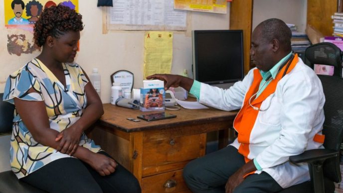 A doctor explaining a IIara Health readiness package to a patient. Courtesy Photo: Pan African Visions