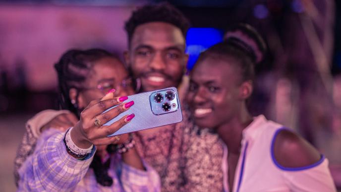 Pictured a group of excited customers taking a selfie with the Infinix HOT 40 Pro. COURTESY PHOTO