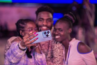 Pictured a group of excited customers taking a selfie with the Infinix HOT 40 Pro. COURTESY PHOTO