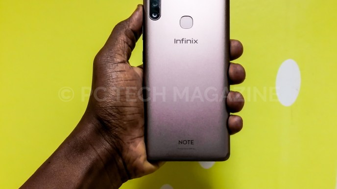 A person holding the Infinix Note 6. It comes with an update and upgrade X-Pen.