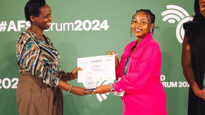 Ecobed Biotech, Director and CEO, Jovia Kisaakye (right) receiving her certificate of recognition and an accolade after winning the Young Female Agripreneur (Rising Star) at 2024 WAYA. COURTESY PHOTO