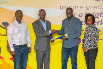 JUMO's Country Manager, Wilfred Wabwire (2L) shakes hands with MTN MoMo Uganda's Managing Director, Richard Yego (3L) upon launching MoSente at the MTN MoMo Uganda Offices in Kololo.