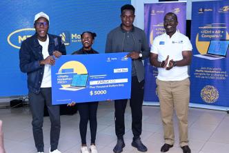 The Kabokisi app developed by a team of three; Paul Barasa Ojiambo, Emmanuel Modi, and Lilian Katsiime pose for a photo with Stephen Mutana (extreme right); MTN MoMo's Chief Strategy & Stakeholder Management officer after they were announced as the overall winners of the 2023 MTN MoMo Hackathon.