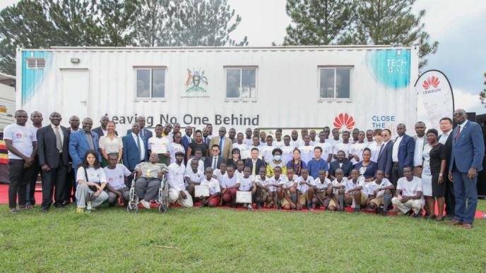 Some of the certified students from the first cohort of digital skills training in the Huawei DigiTruck Project from the Busoga sub-region pose for a group photo with the VP, Jessica Alupo, Rebecca Kadaga, Amb. Zhang Li Zhong and other delegates.