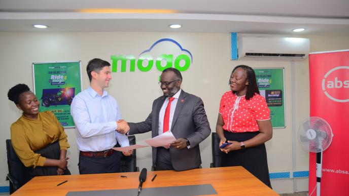 Mogo Uganda CEO Mikhail Vydry (left) and Executive Director and Head of Markets for Absa Bank Uganda, David Wandera (right) shake hands after signing their MoU. Courtesy Photo