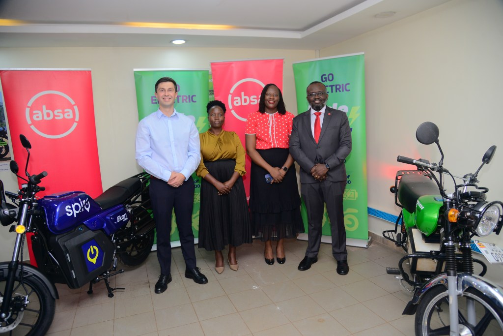 Mogo Uganda and Absa Bank Uganda officials pose for a group photo after signing their MoU. Courtesy Photo