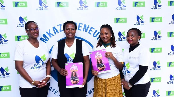 Agnes Mayanja Namyalo, (2nd L), KCB Bank Executive Director and Immy Nakyeyune, (2nd R), Founder of Mkazipreneur pose for a photo with other KCB Bank staff members during the partnership event at Mkazipreneur offices in Kampala yesterday.