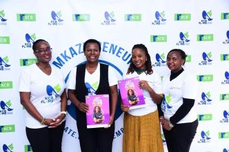 Agnes Mayanja Namyalo, (2nd L), KCB Bank Executive Director and Immy Nakyeyune, (2nd R), Founder of Mkazipreneur pose for a photo with other KCB Bank staff members during the partnership event at Mkazipreneur offices in Kampala yesterday.