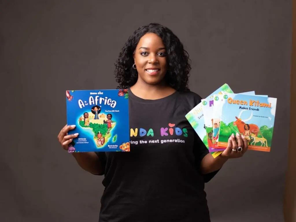 Louisa Kiwana, Co-founder and Director of Kunda Kids Limited poses with some books the company publishes. COURTESY PHOTO