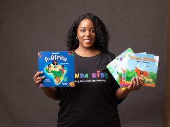 Louisa Kiwana, Co-founder and Director of Kunda Kids Limited poses with some books the company publishes. COURTESY PHOTO