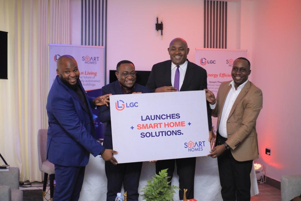 Hon. Chris Baryomunsi (2nd from right) and team from LGC Enterprises (U) Ltd hold pluck card launching the smart homes project at Ham Palm Villas in Uganda.