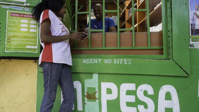 Safaricom: A customer pictured at an M-PESA stall. PHOTO: Philip Mostert