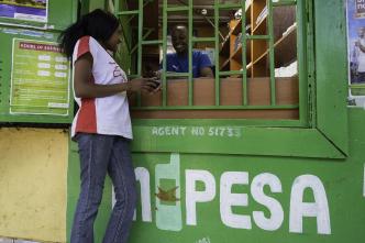 Safaricom: A customer pictured at an M-PESA stall. PHOTO: Philip Mostert