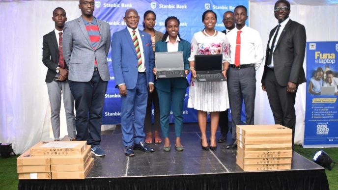 VC Makerere University; Prof. Barnabas Nawangwe (2nd left), Shamim Nambassa; Guild President of Makerere University (center), Stanbic Bank Uganda CEO; Anne Juuko (2nd right) and Sam Mwogeza (right); Executive Head of Consumer & High Net Worth Products at Stanbic Bank Uganda pose for a group photo with other officials. (COURTESY PHOTO)