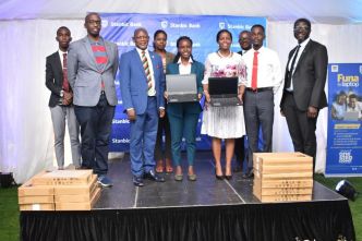 VC Makerere University; Prof. Barnabas Nawangwe (2nd left), Shamim Nambassa; Guild President of Makerere University (center), Stanbic Bank Uganda CEO; Anne Juuko (2nd right) and Sam Mwogeza (right); Executive Head of Consumer & High Net Worth Products at Stanbic Bank Uganda pose for a group photo with other officials. (COURTESY PHOTO)