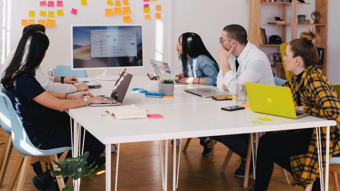 Pictured, is a team in an office discussing customer reference during a meeting. PHOTO: You X Ventures on Unsplash