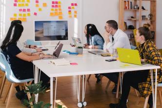 Pictured, is a team in an office discussing customer reference during a meeting. PHOTO: You X Ventures on Unsplash