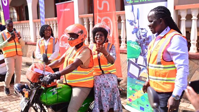 Minister for Science, Technology, and Innovation Dr. Monica Musenero Masanza pictured trying out the Zembo electric bike a new Tier in the SafeBoda App while SafeBoda co-founder; Ricky Rapa Thomson (right) looks on. COURTESY PHOTO / SafeBoda